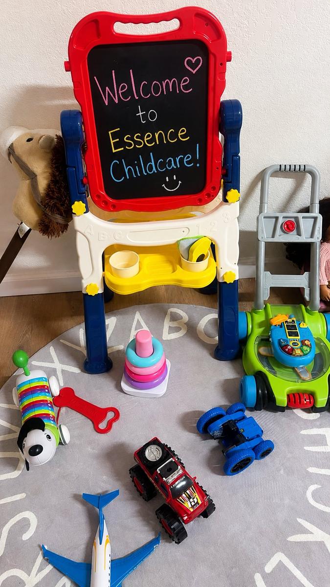 A chalkboard easel in the ECU play area reading Welcome to Essence Childcare